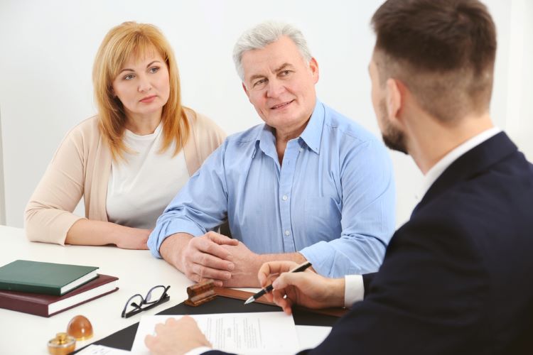 Senior couple discussing power of attorney documents with lawyer
